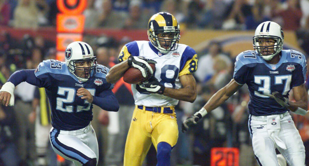 Tennessee Titans defenders Blaine Bishop (23) and Dainon Sidney (37) pursue St. Louis Rams receiver Torry Holt (88) during the second quarter of Super Bowl XXXIV inside the Georgia Dome Jan. 30, 2000. Tennessee Titans Vs St Louis Rams In Super Bowl Xxxiv Football