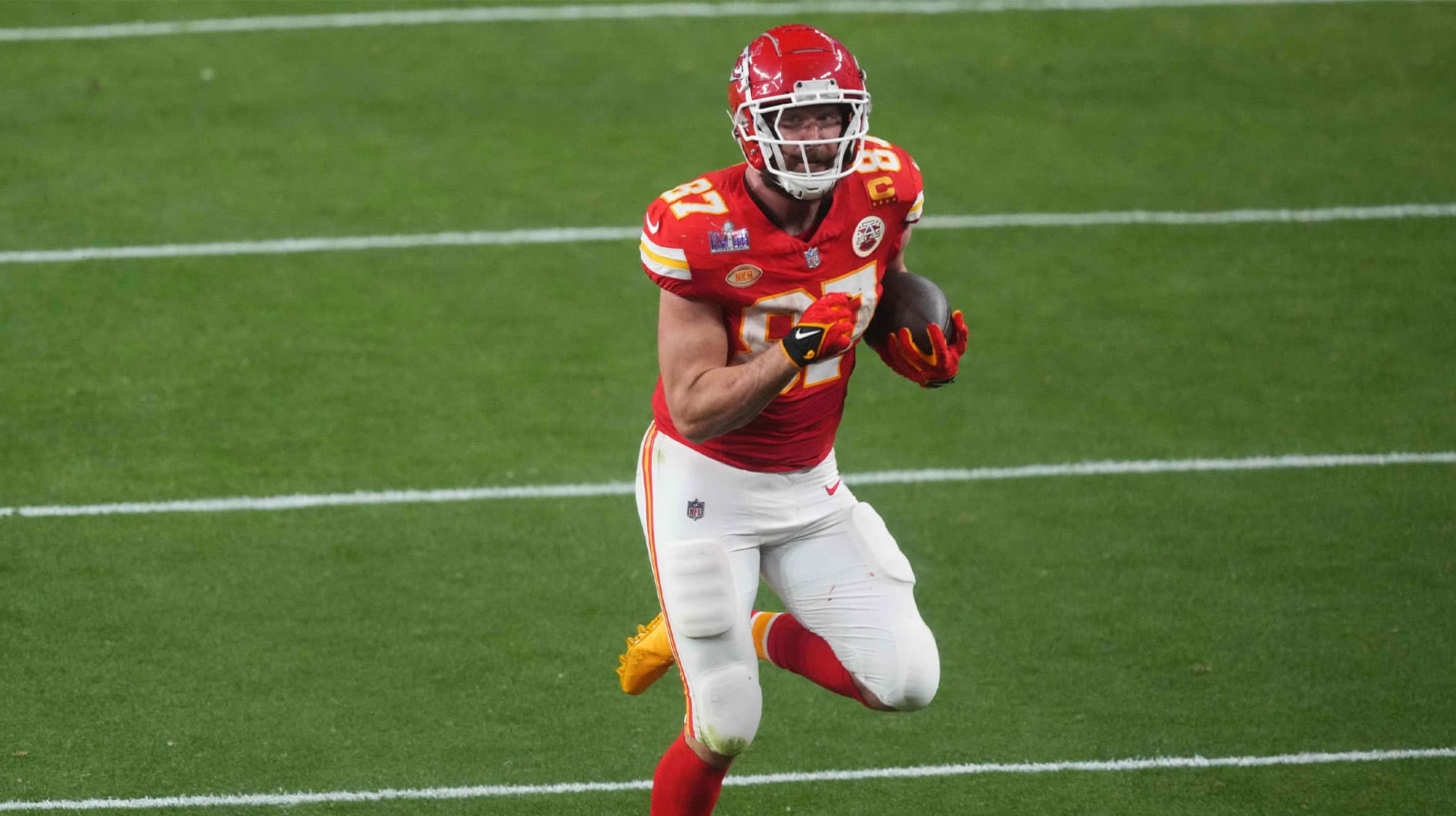 Kansas City Chiefs tight end Travis Kelce (87) runs with the ball during overtime against the San Francisco 49ers of Super Bowl LVIII at Allegiant Stadium.
