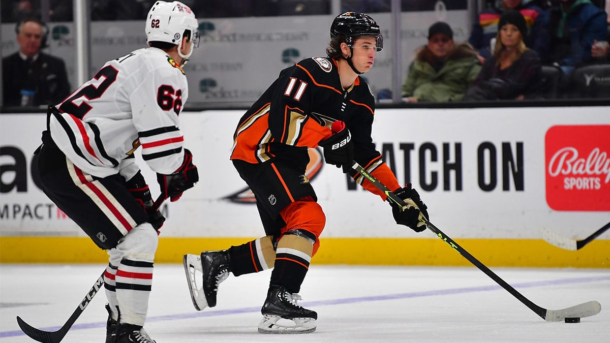 Anaheim Ducks center Trevor Zegras (11) moves the puck ahead of Chicago Blackhawks left wing Brett Seney (62) during the second period at Honda Center.