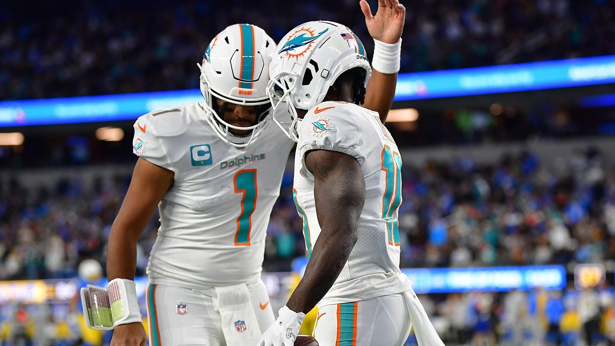 Miami Dolphins wide receiver Tyreek Hill (10) celebrates his touchdown scored against the Los Angeles Chargers with quarterback Tua Tagovailoa (1) during the first half at SoFi Stadium.