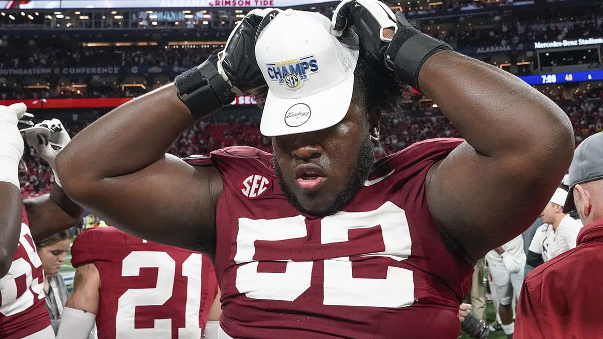 Alabama Crimson Tide offensive lineman Tyler Booker (52) wears an SEC Championship hat at Mercedes-Benz Stadium. Alabama defeated Georgia 27-24 to claim the SEC Championship. 