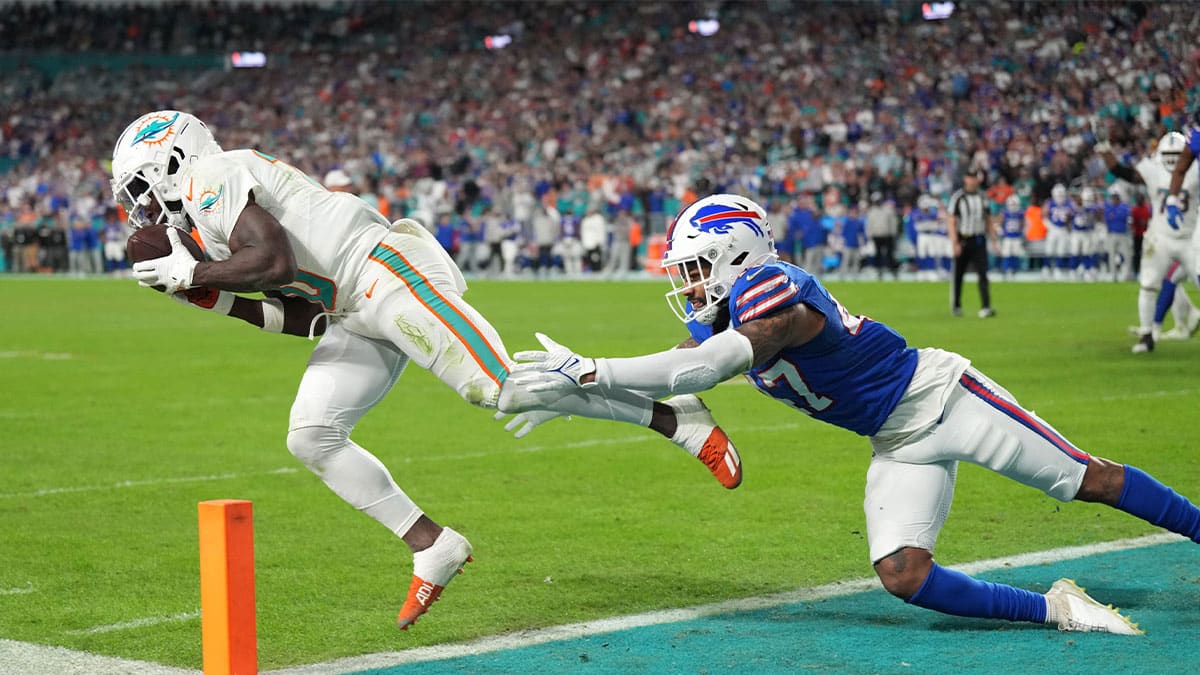  Miami Dolphins wide receiver Tyreek Hill (10) catches a touchdown as Buffalo Bills cornerback Christian Benford (47) defends on the play during the first half at Hard Rock Stadium.