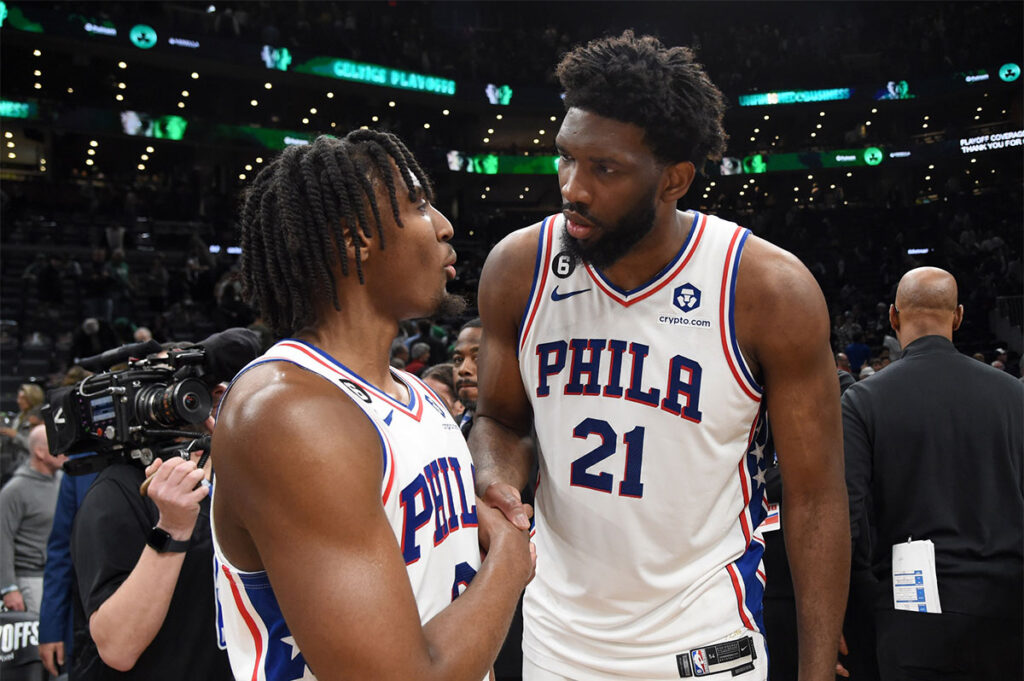 Philadelphia 76ers guard Tyrese Maxey (0) and center Joel Embiid (21) shake hands after defeating the Boston Celtics in game five of the 2023 NBA playoffs at TD Garden. 