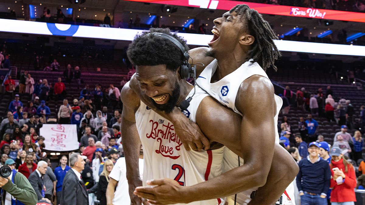 Philadelphia 76ers guard Tyrese Maxey (0) leaps onto center Joel Embiid (21) after Embiids 59 points in a victory against the Utah Jazz at Wells Fargo Center. 