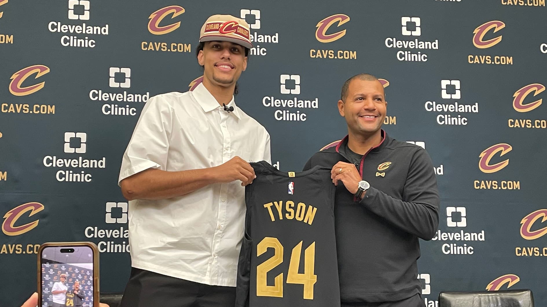 Cavaliers first-round draft pick Jaylon Tyson and president of basketball operations Koby Altman hold a jersey during Tyson's introductory news conference Thursday, June 27, in Independence. The Cavs chose Tyson 20th overall.