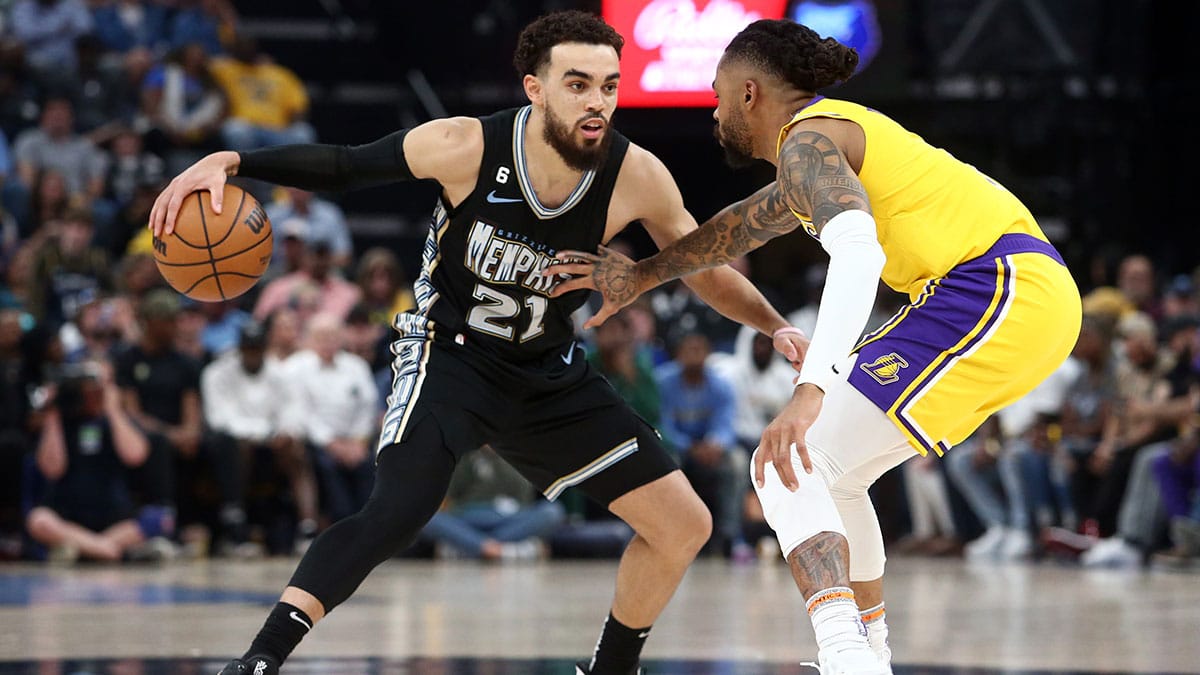 Memphis, Tennessee, USA; Memphis Grizzlies guard Tyus Jones (21) dribbles as Los Angeles Lakers guard D'Angelo Russell (1) defends during the second half during game two of the 2023 NBA playoffs at FedExForum.