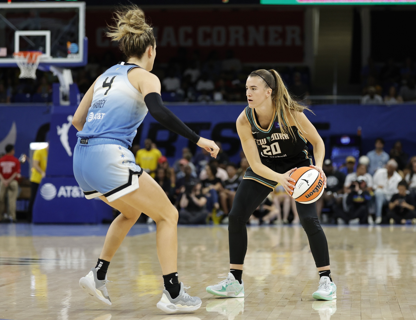 Jul 13, 2024; Chicago, Illinois, USA; New York Liberty guard Sabrina Ionescu (20) is defended by Chicago Sky guard Marina Mabrey (4) during the first half of a WNBA game at Wintrust Arena. Mandatory Credit: Kamil Krzaczynski-USA TODAY Sports