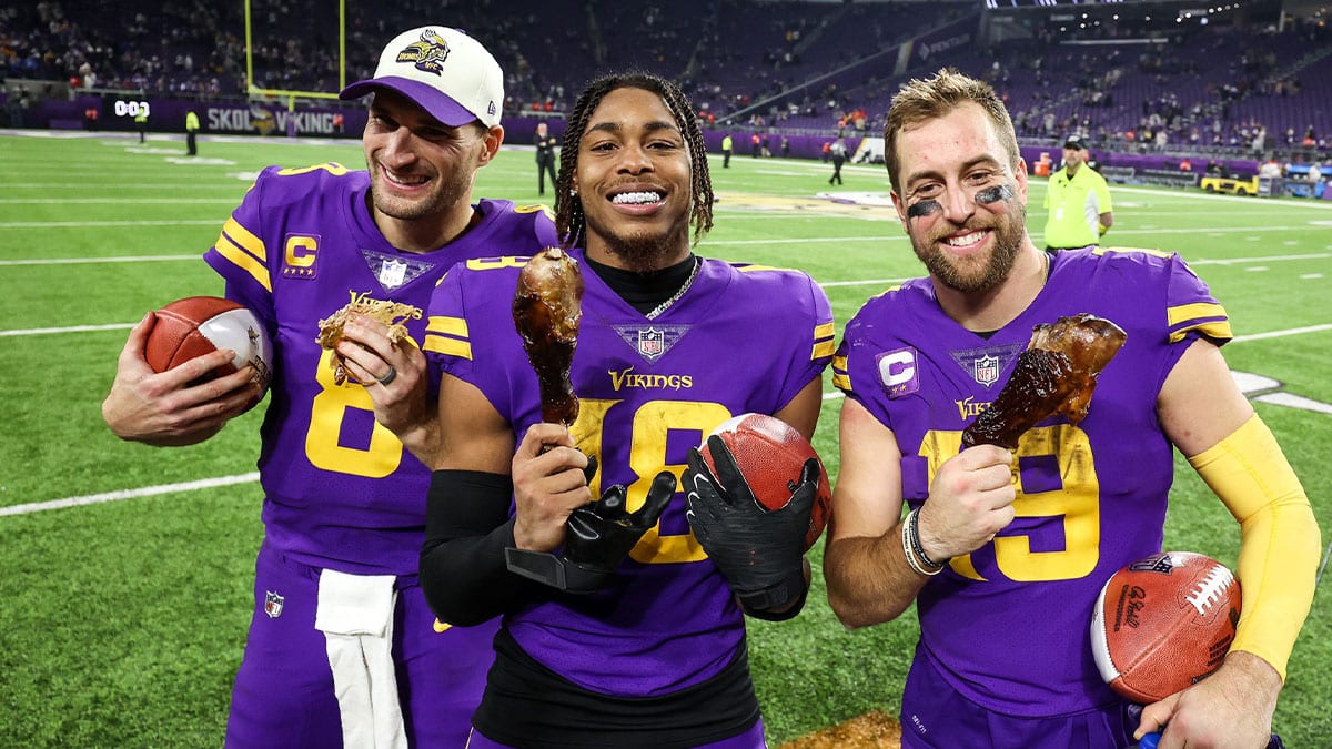 Minnesota Vikings quarterback Kirk Cousins (8), wide receiver Justin Jefferson (18), and wide receiver Adam Thielen (19) celebrate the win against the New England Patriots after the game at U.S. Bank Stadium.