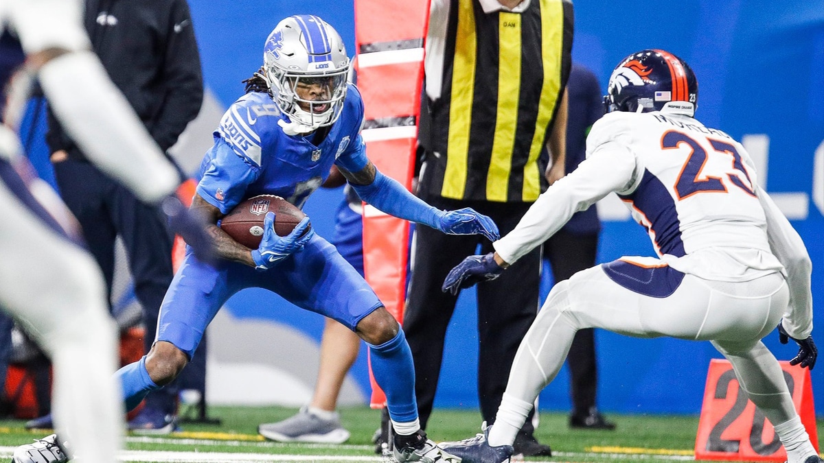 Detroit Lions wide receiver Jameson Williams (9) runs after a reception against Denver Broncos cornerback Fabian Moreau (23) during the first half at Ford Field in Detroit on Saturday, Dec. 16, 2023.