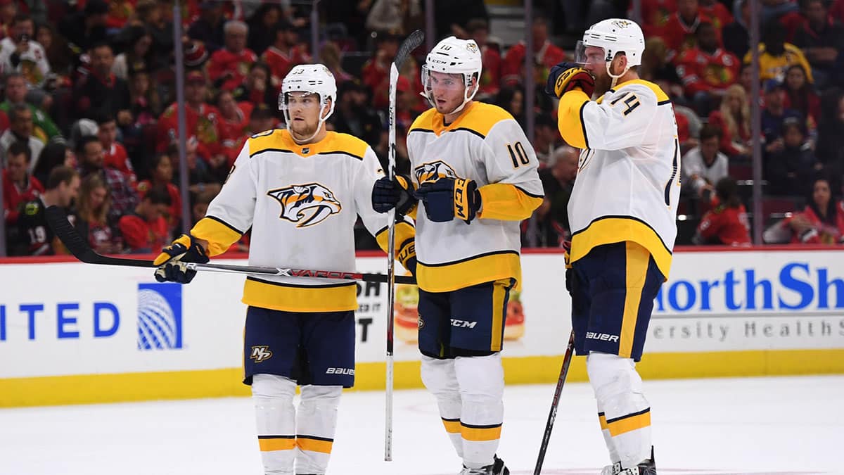 Nashville Predators left wing Viktor Arvidsson (left), center Colton Sissons (center), and defenseman Mattias Ekholm (right) wait before an overtime face-off during a game against the Chicago Blackhawks at United Center.