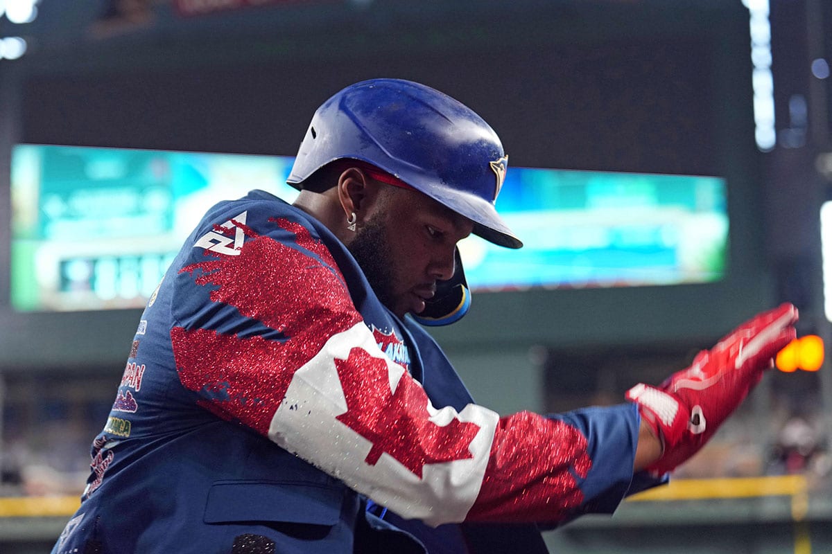 Toronto Blue Jays first base Vladimir Guerrero Jr. (27) celebrates with a custom jacket after hitting a solo run home run against the Arizona Diamondbacks during the seventh inning at Chase Field.