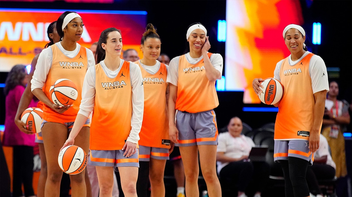 Sky forward Angel Reese (L) and Fever guard Caitlin Clark (second from left) stand with their teammates as they shoot half court shots during WNBA All-Star practice on Media Day at the Footprint Center.