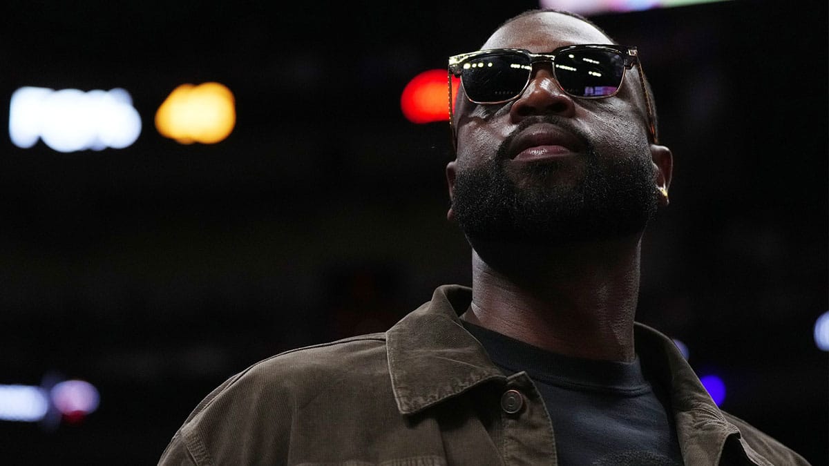 ; Former Miami Heat player Dwayne Wade walks court-side during the second half of the game between the Miami Heat and the Atlanta Hawks at Kaseya Center.