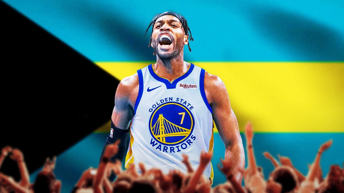 New Golden State Warriors shooting guard Buddy Hield in front of the flag of the Bahamas