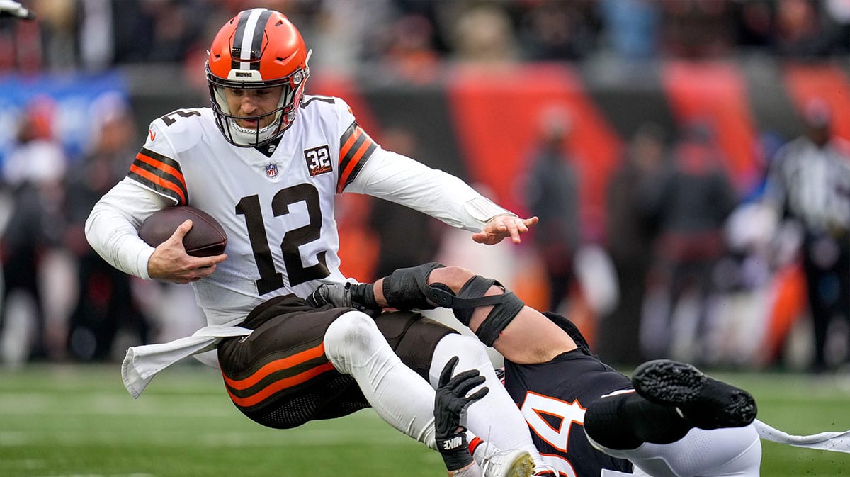 Cleveland Browns quarterback Jeff Driskel (12) is sacked by Cincinnati Bengals defensive end Sam Hubbard (94) in the first quarter of the NFL Week 18 game between the Cincinnati Bengals and the Cleveland Browns at Paycor Stadium in downtown Cincinnati.