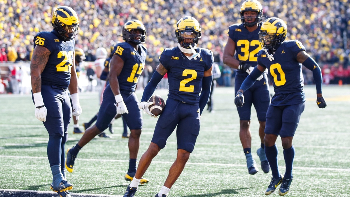 Michigan defensive back Will Johnson celebrates after intercepting a pass from Ohio State quarterback Kyle McCord during the first half at Michigan Stadium