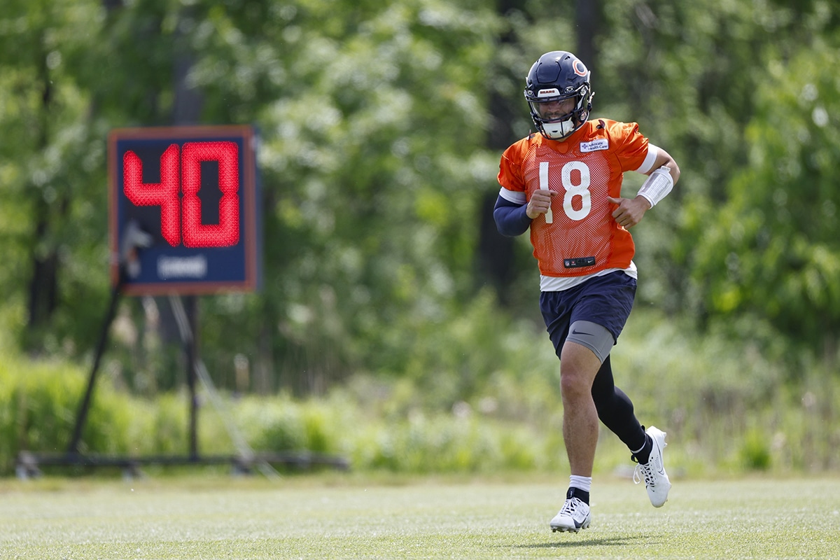  Chicago Bears quarterback Caleb Williams (18) runs on the field during organized team activities at Halas Hall.