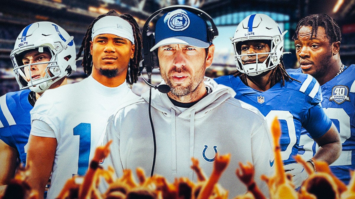 Coach Shane Steichen in the middle, Alec Pierce, Adonai Mitchell, Jelani Woods, Samson Ebukam around him, Indianapolis Colts wallpaper in the background