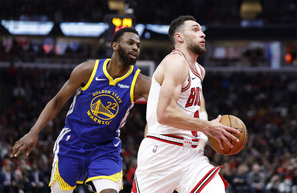 Chicago Bulls guard Zach LaVine (8) drives against Golden State Warriors forward Andrew Wiggins (22) during the second half at United Center. 