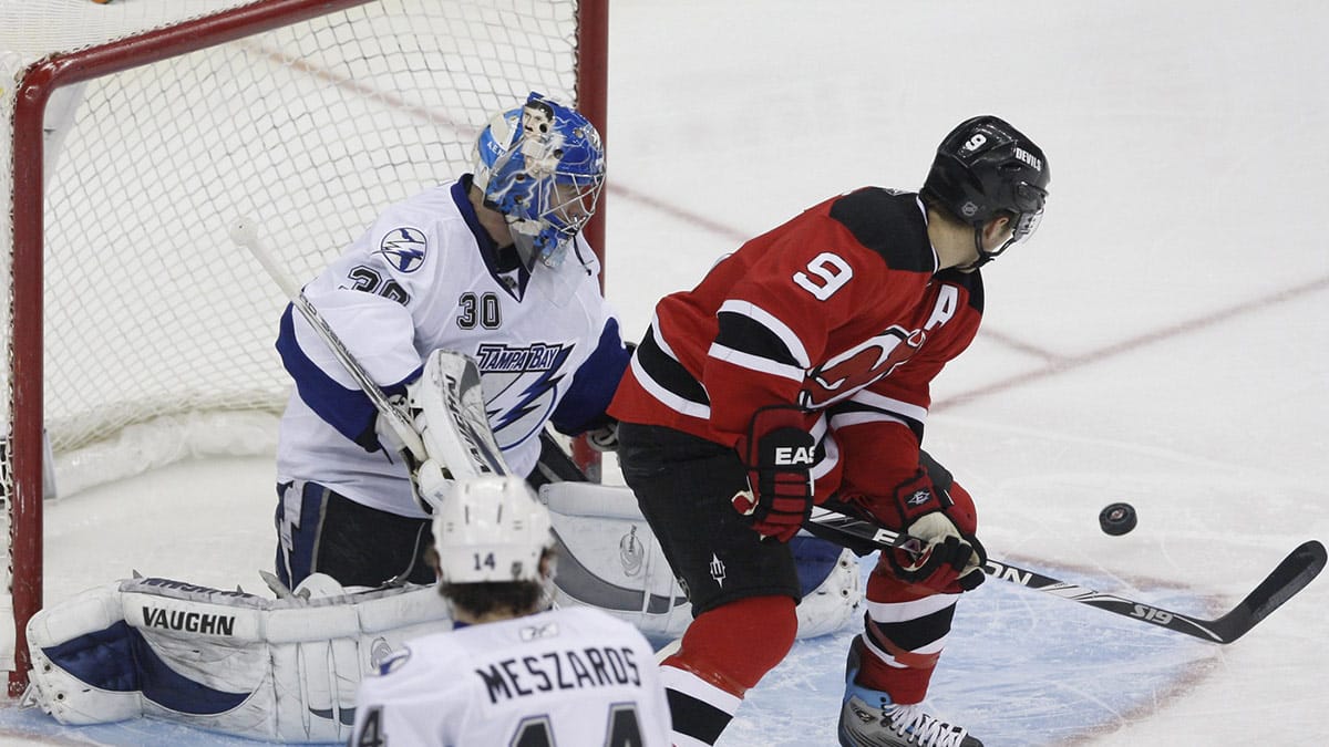 New Jersey Devils left wing Zach Parise (9) tips a shot wide of Tampa Bay Lightning goalie Antero Niittymaki (30) during the first period at the Prudential Center.