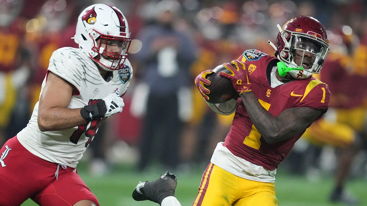 Southern California Trojans wide receiver Zachariah Branch (1) catches the ball against Louisville Cardinals defensive lineman Stephen Herron (14) in the first half of the Holiday Bowl at Petco Park