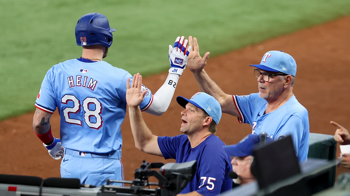 Jul 21, 2024; Arlington, Texas, USA; Texas Rangers catcher Jonah Heim (28) celebrates with Texas Rangers manager Bruce Bochy (15) after hitting a three run home run during the fourth inning against the Baltimore Orioles at Globe Life Field. Mandatory Credit: Kevin Jairaj-USA TODAY Sports
