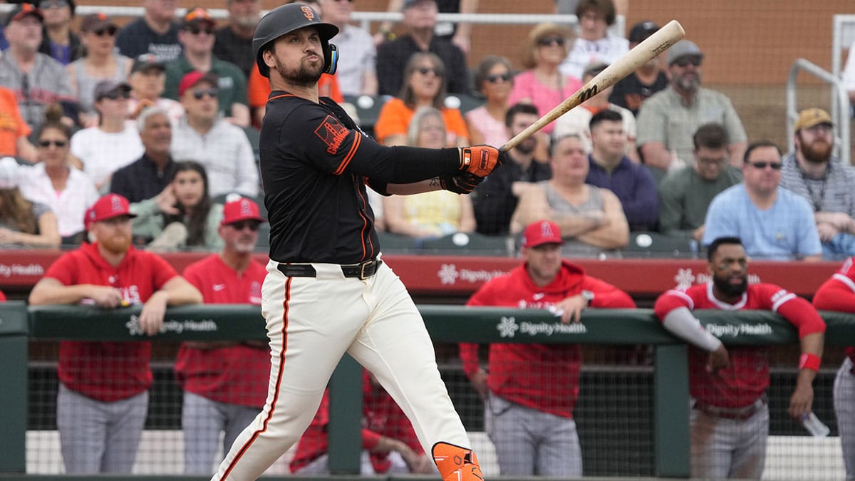 Feb 26, 2024; Scottsdale, Arizona, USA; San Francisco Giants third baseman JD Davis (7) hits against the Los Angeles Angels in the first inning at Scottsdale Stadium. Mandatory Credit: Rick Scuteri-USA TODAY Sports