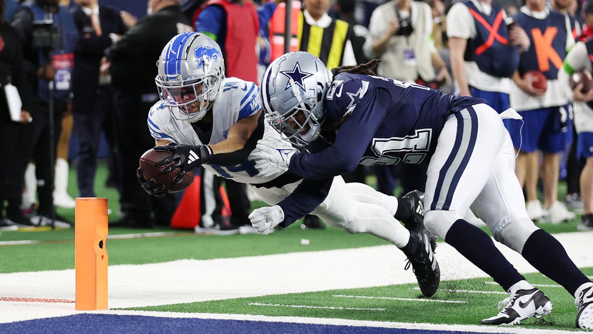 Dec 30, 2023; Arlington, Texas, USA; Detroit Lions wide receiver Amon-Ra St. Brown (14) scores a touchdown against Dallas Cowboys cornerback Stephon Gilmore (21) in the fourth quarter at AT&T Stadium. Mandatory Credit: Tim Heitman-USA TODAY Sports