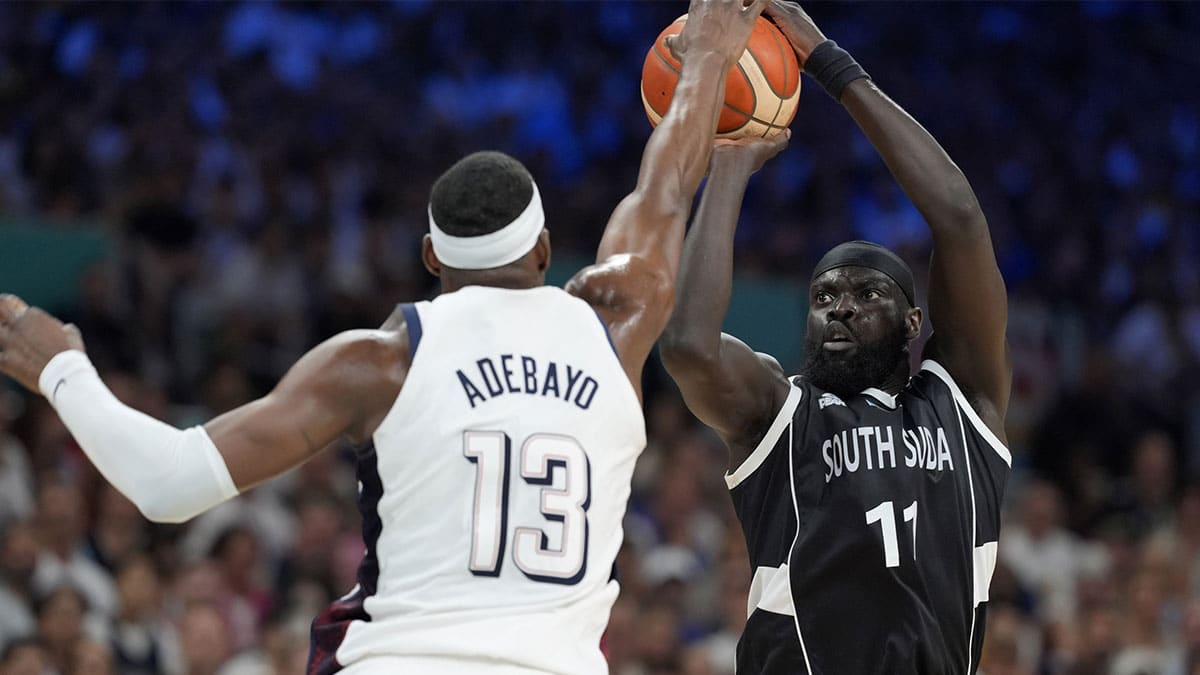 Jul 31, 2024; Villeneuve-d'Ascq, France; South Sudan point guard Marial Shayok (11) shoots against United States center Bam Adebayo (13) in the second quarter during the Paris 2024 Olympic Summer Games at Stade Pierre-Mauroy. Mandatory Credit: John David Mercer-USA TODAY Sports