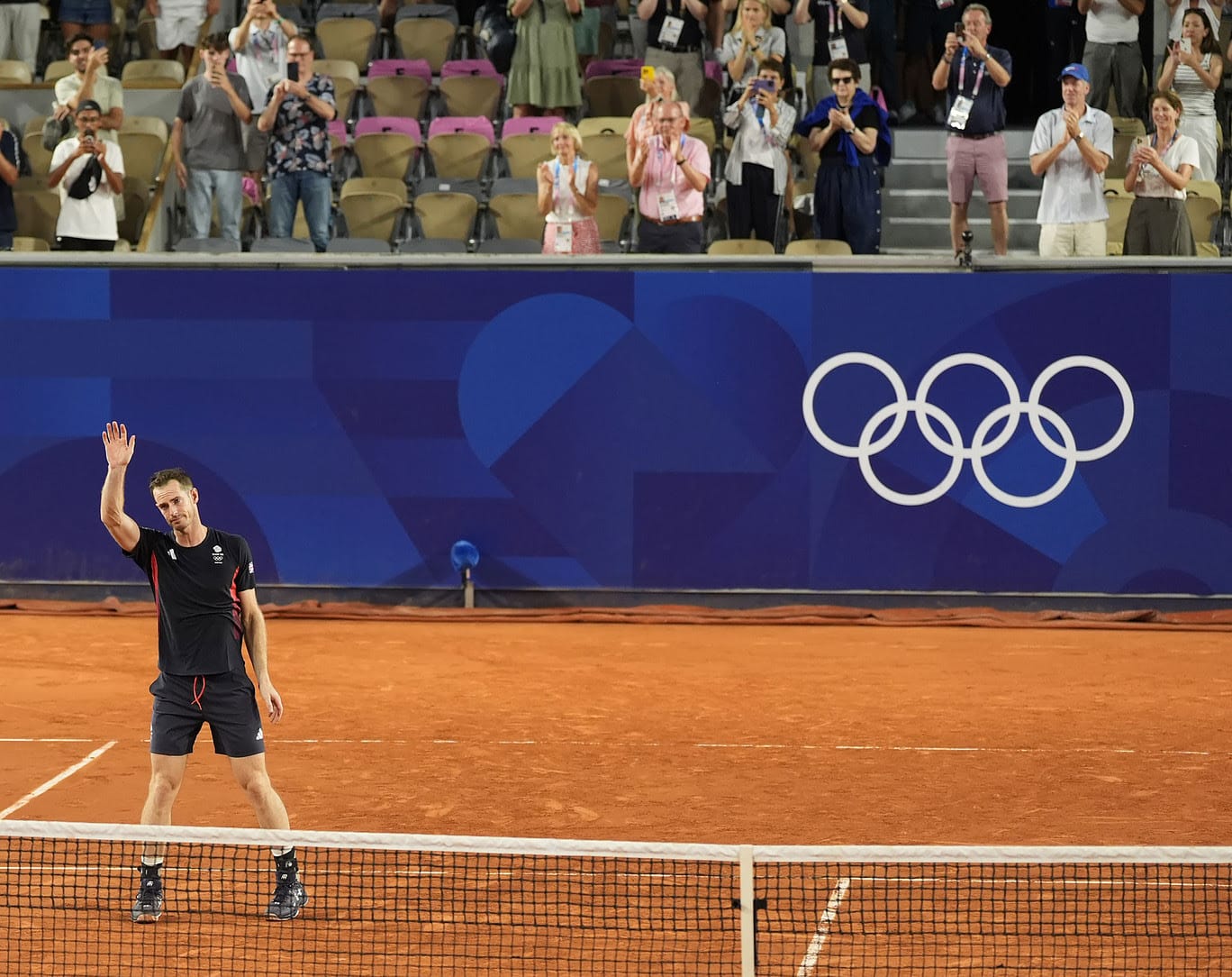Andy Murray (GBR) waves to the crowd after a men's doubles quarterfinal match during the Paris 2024 Olympic Summer Games at Stade Roland Garros.