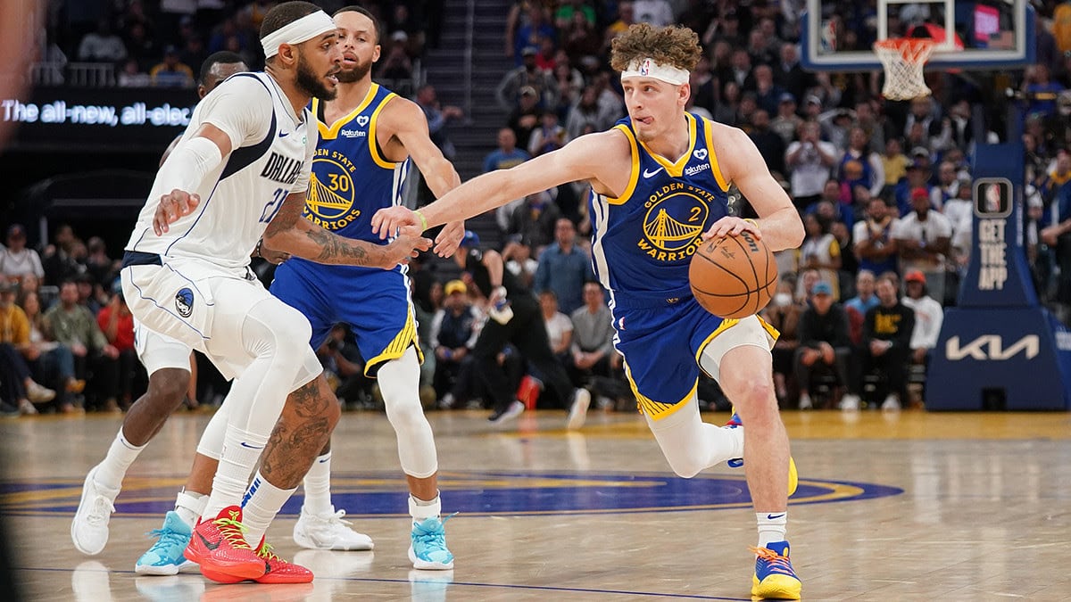 Golden State Warriors guard Brandin Podziemski (2) dribbles past Dallas Mavericks center Daniel Gafford (21) in the fourth quarter at the Chase Center.