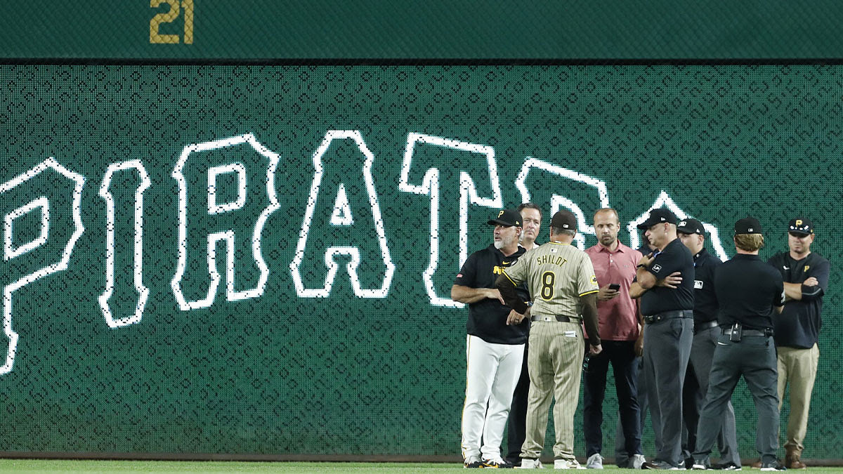 Pittsburgh Pirates ballpark operations management along with Pirates manager Derek Shelton (17) and San Diego Padres manager Mike Shildt (8) assess the field along with the umpire crew to determine player safety after a heavy rain delayed the game in the second inning at PNC Park.