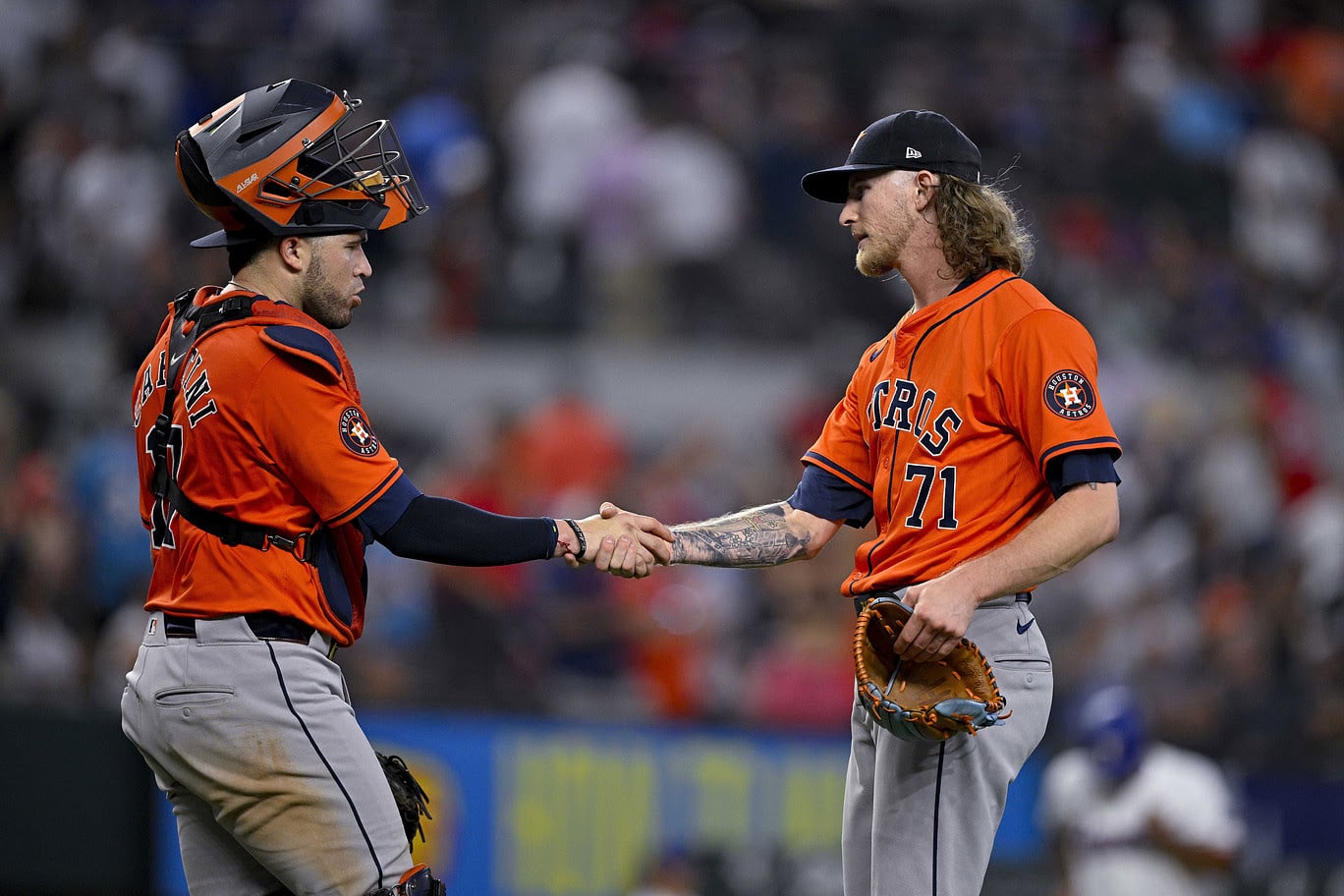 Houston Astros catcher Victor Caratini (17) shakes hands with relief pitcher Josh Hader (71) after the Astros defeat the Texas Rangers at Globe Life Field.