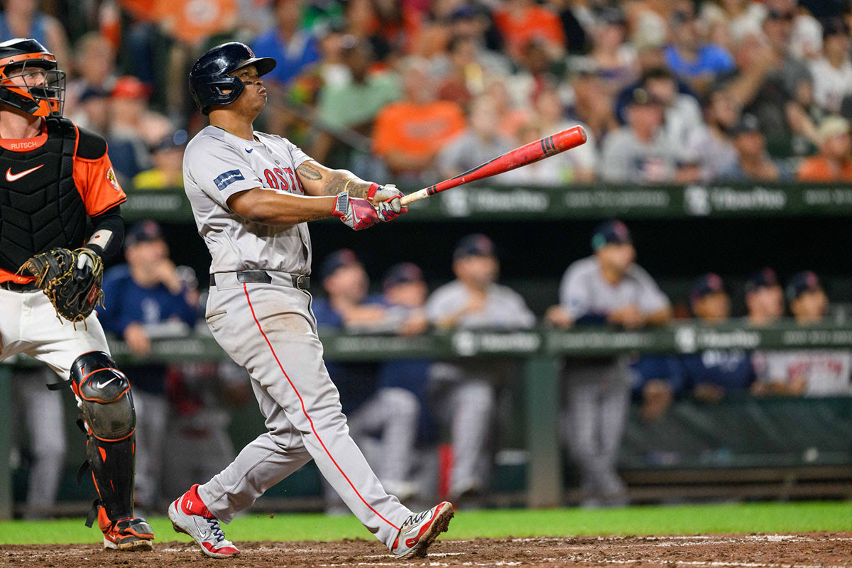 Boston Red Sox third baseman Rafael Devers (11) hits a home run during the eighth inning against the Baltimore Orioles at Oriole Park at Camden Yards.