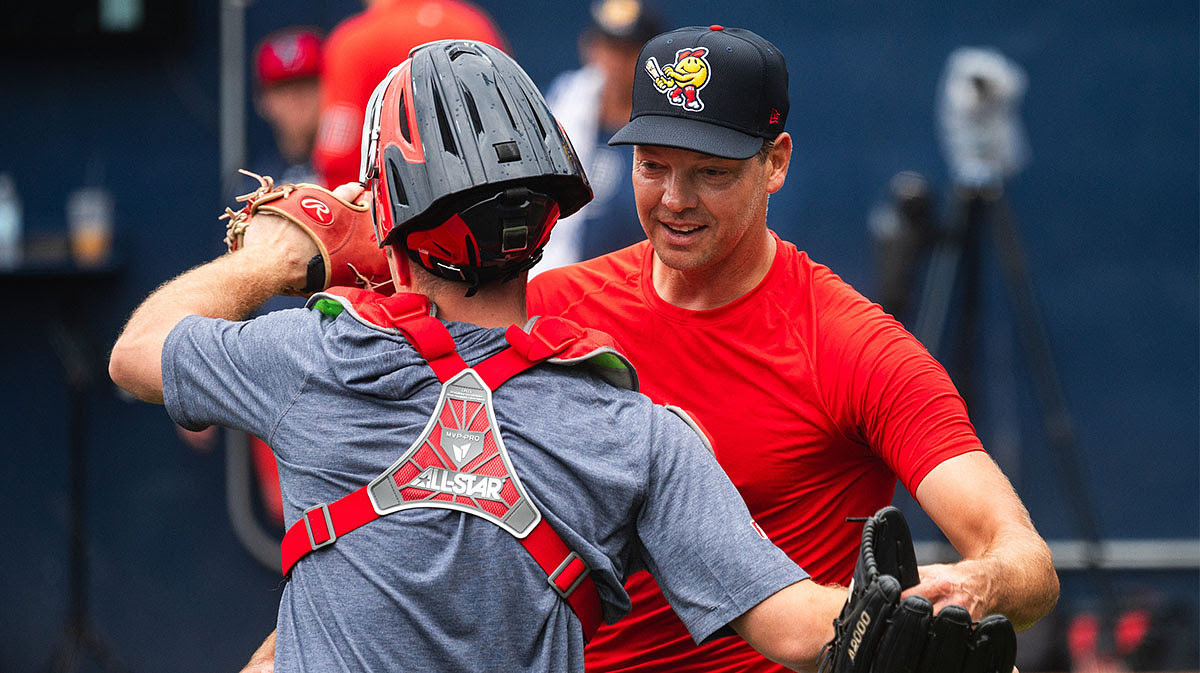 Left-handed pitcher Rich Hill hugs WooSox catcher Kyle Teel after the two shared a bullpen session on Aug. 18, 2024, at Polar Park.