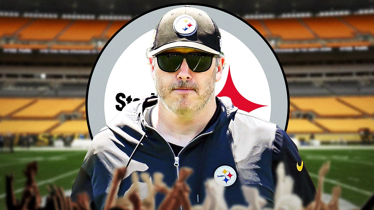 Steelers OC Arthur Smith in front of Steelers stadium/logo