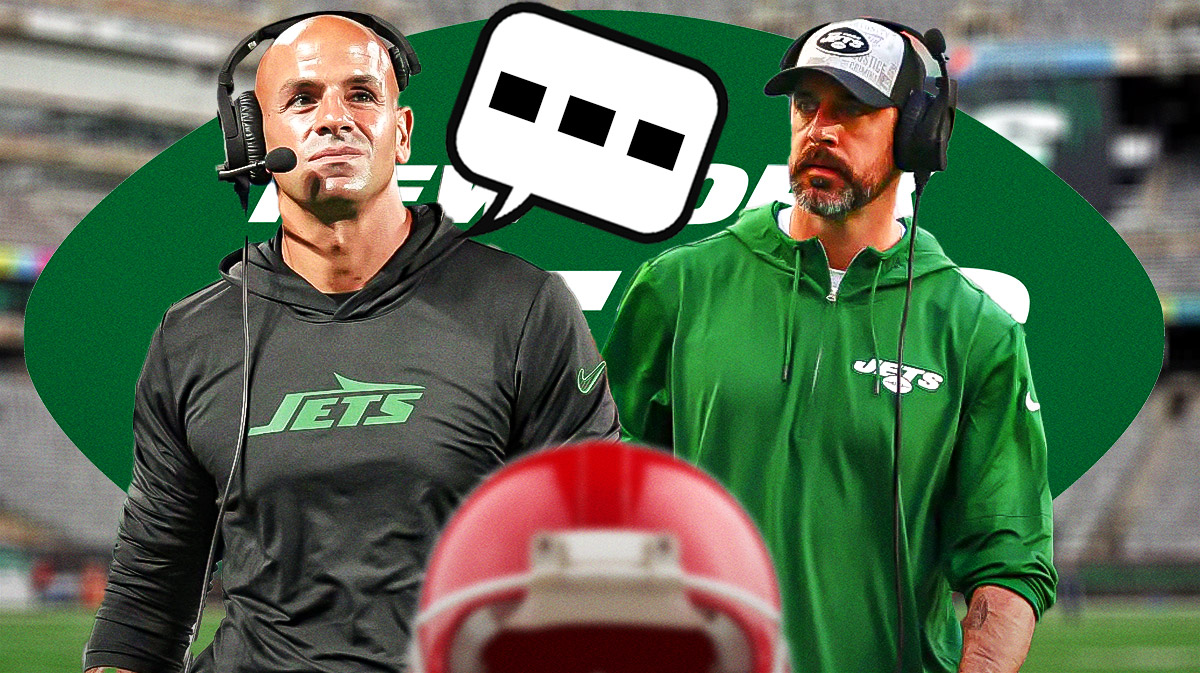 New York Jets head coach Robert Saleh with QB Aaron Rodgers. Saleh has a speech bubble with the three dots emoji inside. There is also a logo for the New York Jets.