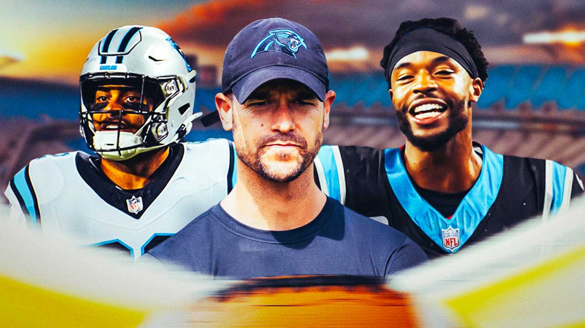 Coach Dave Canales in the middle, Tommy Tremble, Dane Jackson around him, Carolina Panthers wallpaper in the background