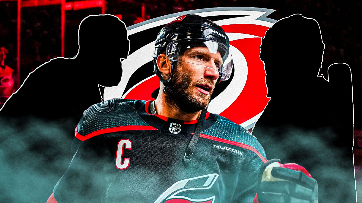 Jordan Staal in middle looking stern, the silhouette of Brent Burns and Frederik Andersen on either side, Carolina Hurricanes logo, hockey rink in background