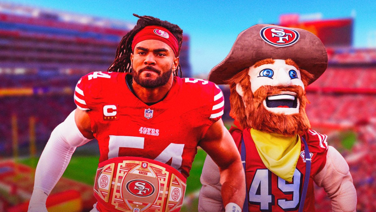 Fred Warner wearing the attached belt next to the 49ers mascot in front of Levi Stadium.