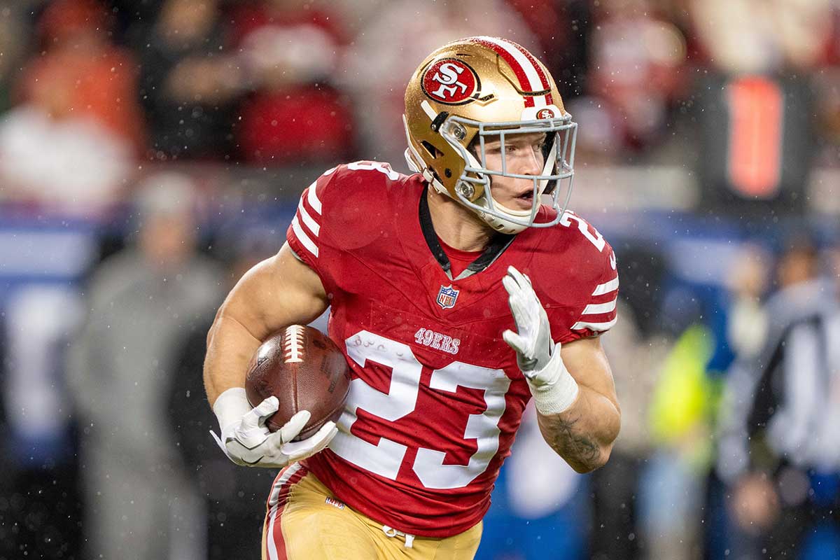 San Francisco 49ers running back Christian McCaffrey (23) runs the ball against the Green Bay Packers during the first quarter in a 2024 NFC divisional round game at Levi's Stadium.