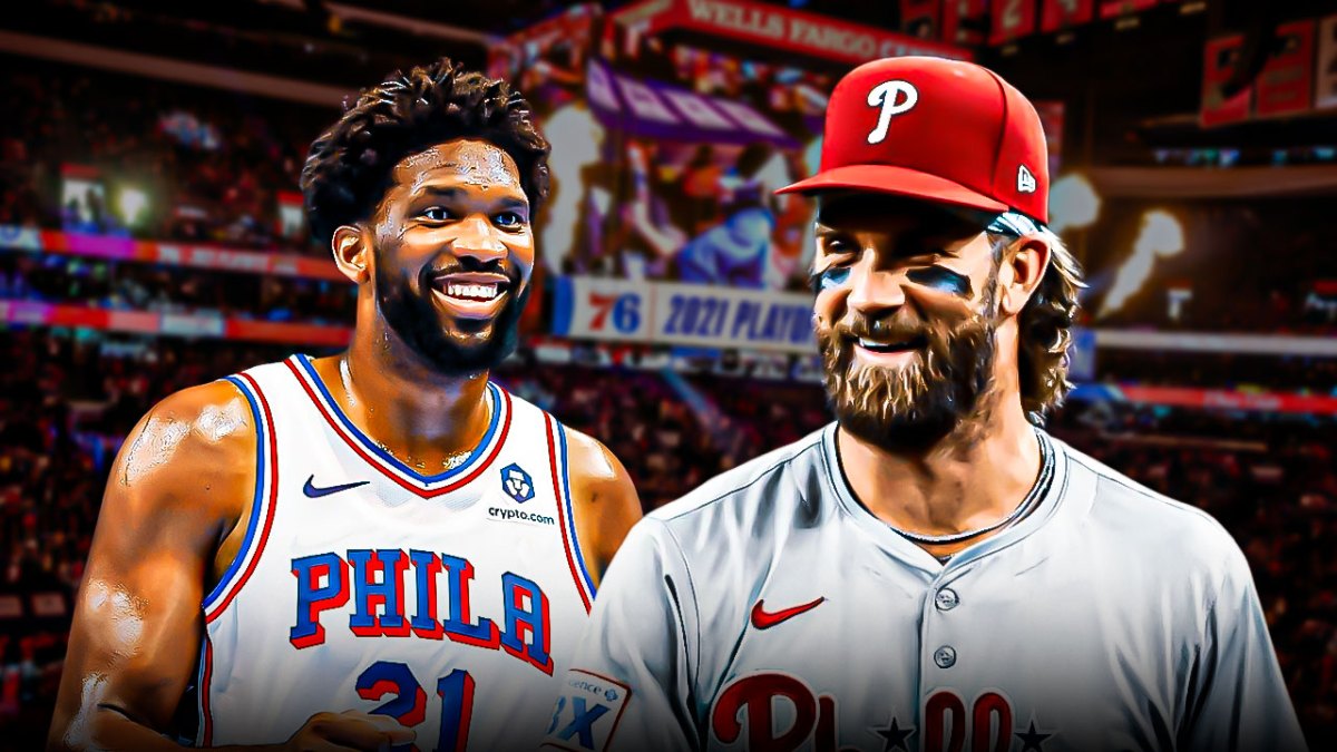 76ers' Joel Embiid hyped up, with Phillies' Bryce Harper smiling at him