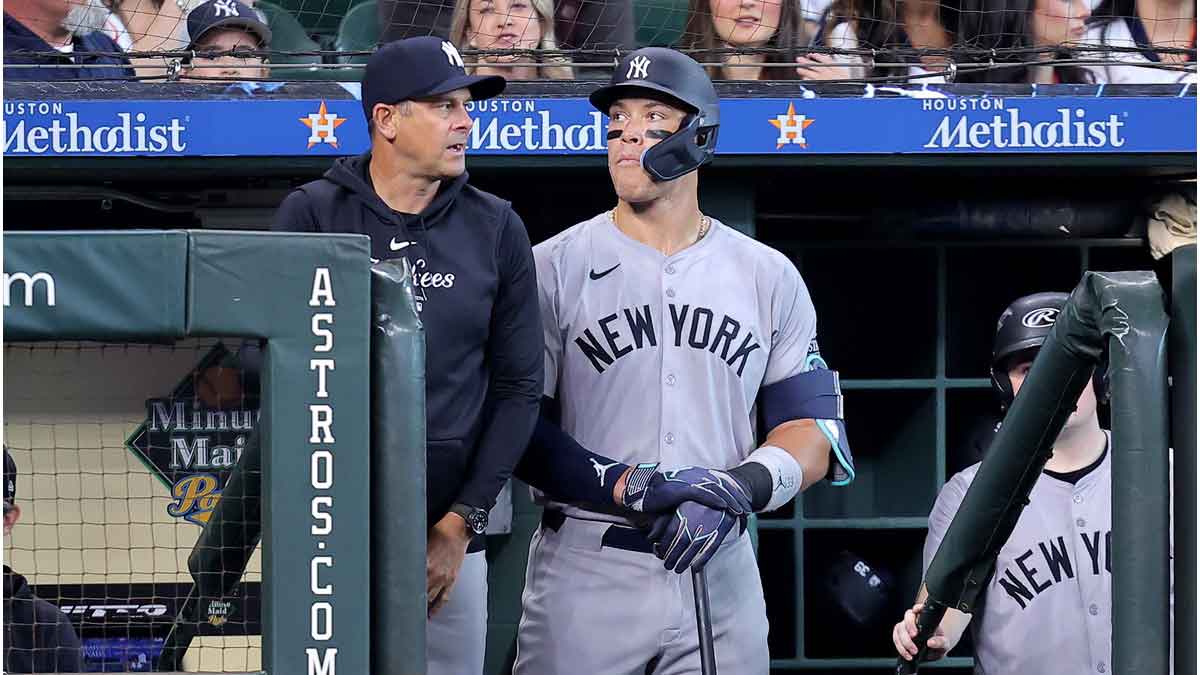 New York Yankees manager Aaron Boone (17) and New York Yankees center fielder Aaron Judge (99) watch the action from the dugout against the Houston Astros during the first inning at Minute Maid Park.