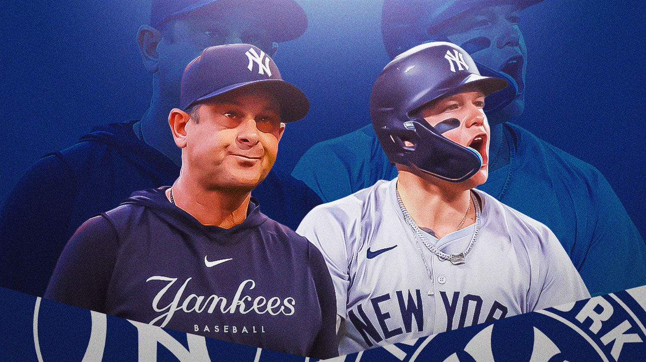 Aaron Boone stands next to Alex Verdugo in Yankees gear
