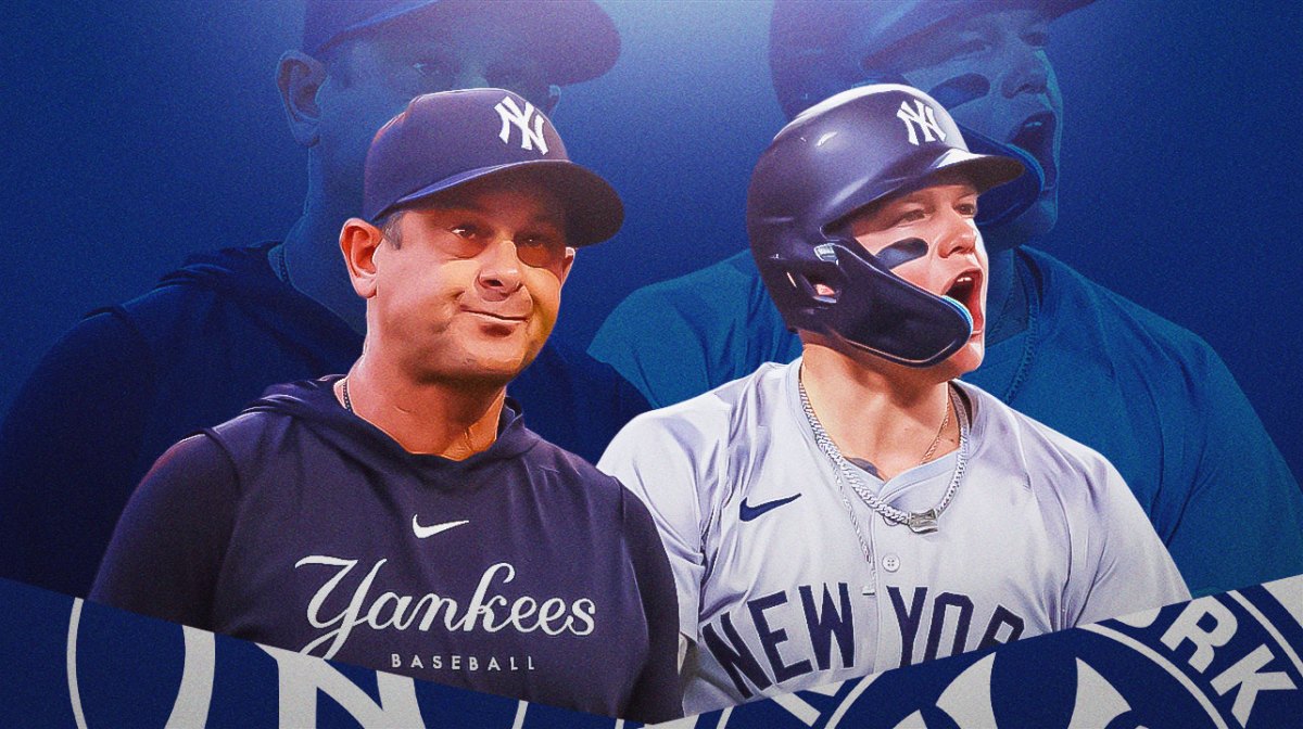 Aaron Boone stands next to Alex Verdugo in Yankees gear