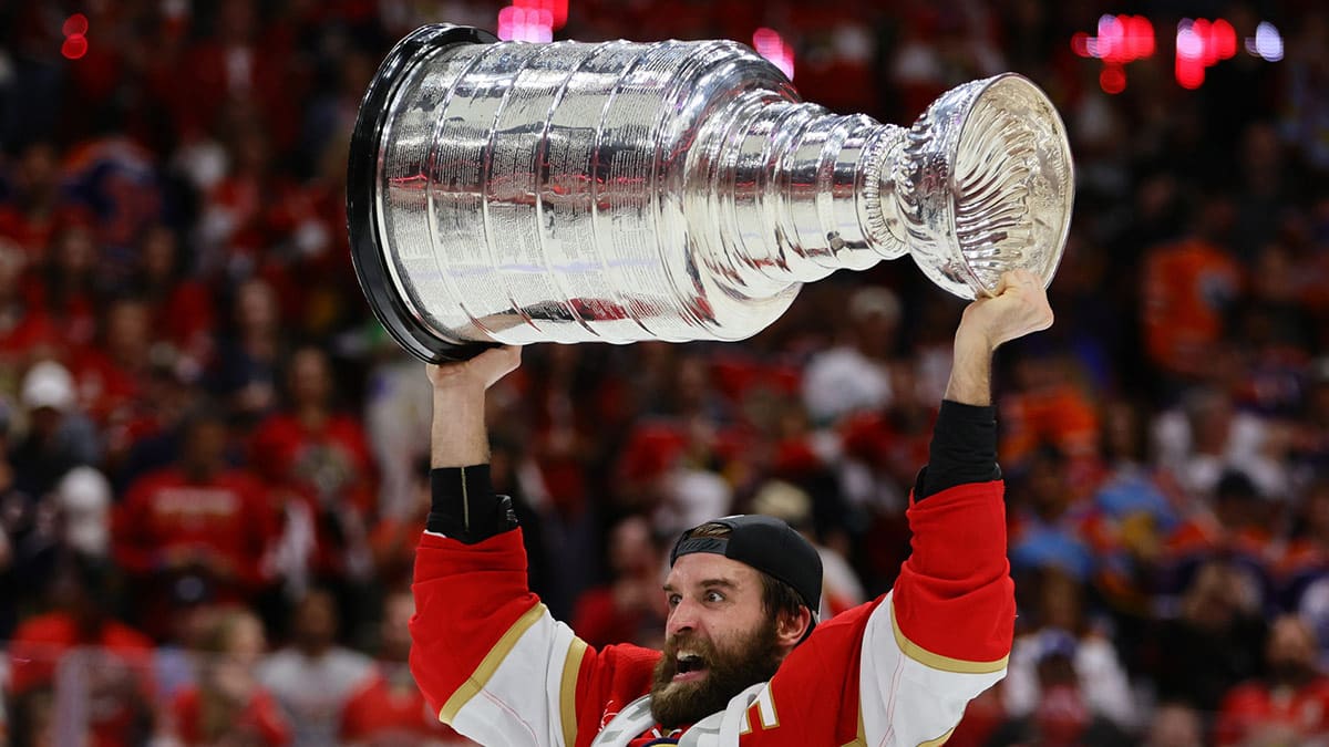 Florida Panthers defenseman Aaron Ekblad (5) hoists the Stanley Cup after defeating the Edmonton Oilers in game seven of the 2024 Stanley Cup Final at Amerant Bank Arena. 