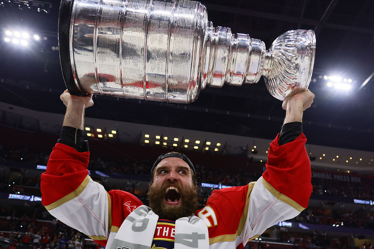     Florida Panthers defenseman Aaron Ekblad (5) raises the Stanley Cup after defeating the Edmonton Oilers in game seven of the 2024 Stanley Cup Final at Amerant Bank Arena. 