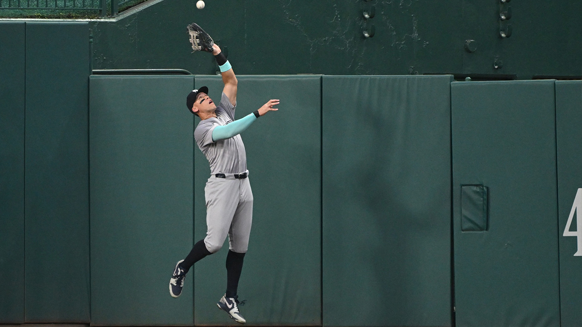 New York Yankees center fielder Aaron Judge (99) leaps to make a catch agains the wall against the Washington Nationals during the second inning at Nationals Park.