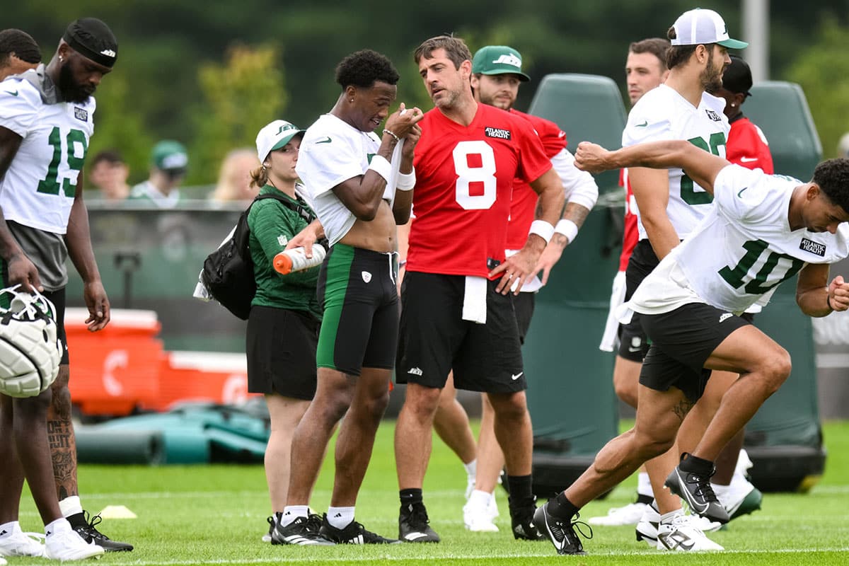 New York Jets quarterback Aaron Rodgers (8) talks to wide receiver Garrett Wilson (5) during training camp at the Atlantic Health Jets Training Center