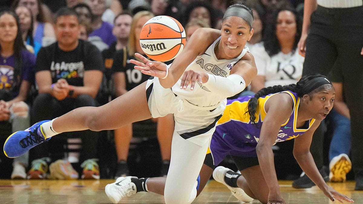 Las Vegas Aces center A'ja Wilson (22) passes the ball against LA Sparks guard Aari McDonald (15) in the first half at Crypto.com Arena.